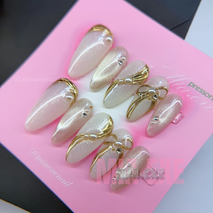 Press on Nails | Pearlescent Nude Cat Eye with Gold Swirl & Pearl Bow Accents, Daily Nail Style, Stiletto Shape, Medium Length Luxury Handmade Fake Nails