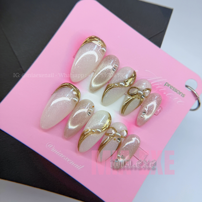 Press on Nails | Pearlescent Nude Cat Eye with Gold Swirl & Pearl Bow Accents, Daily Nail Style, Stiletto Shape, Medium Length Luxury Handmade Fake Nails