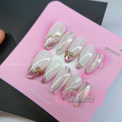 Press on Nails | Nude & Gold Glitter Swirl with Bow Charm, Daily Nail Style, Almond Shape, Medium Length Luxury Handmade Fake Nails