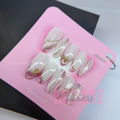 Press on Nails | Nude & Gold Glitter Swirl with Bow Charm, Daily Nail Style, Almond Shape, Medium Length Luxury Handmade Fake Nails