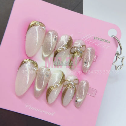 Press on Nails | Pearlescent Nude Cat Eye with Gold Swirl & Pearl Bow Accents, Daily Nail Style, Stiletto Shape, Medium Length Luxury Handmade Fake Nails